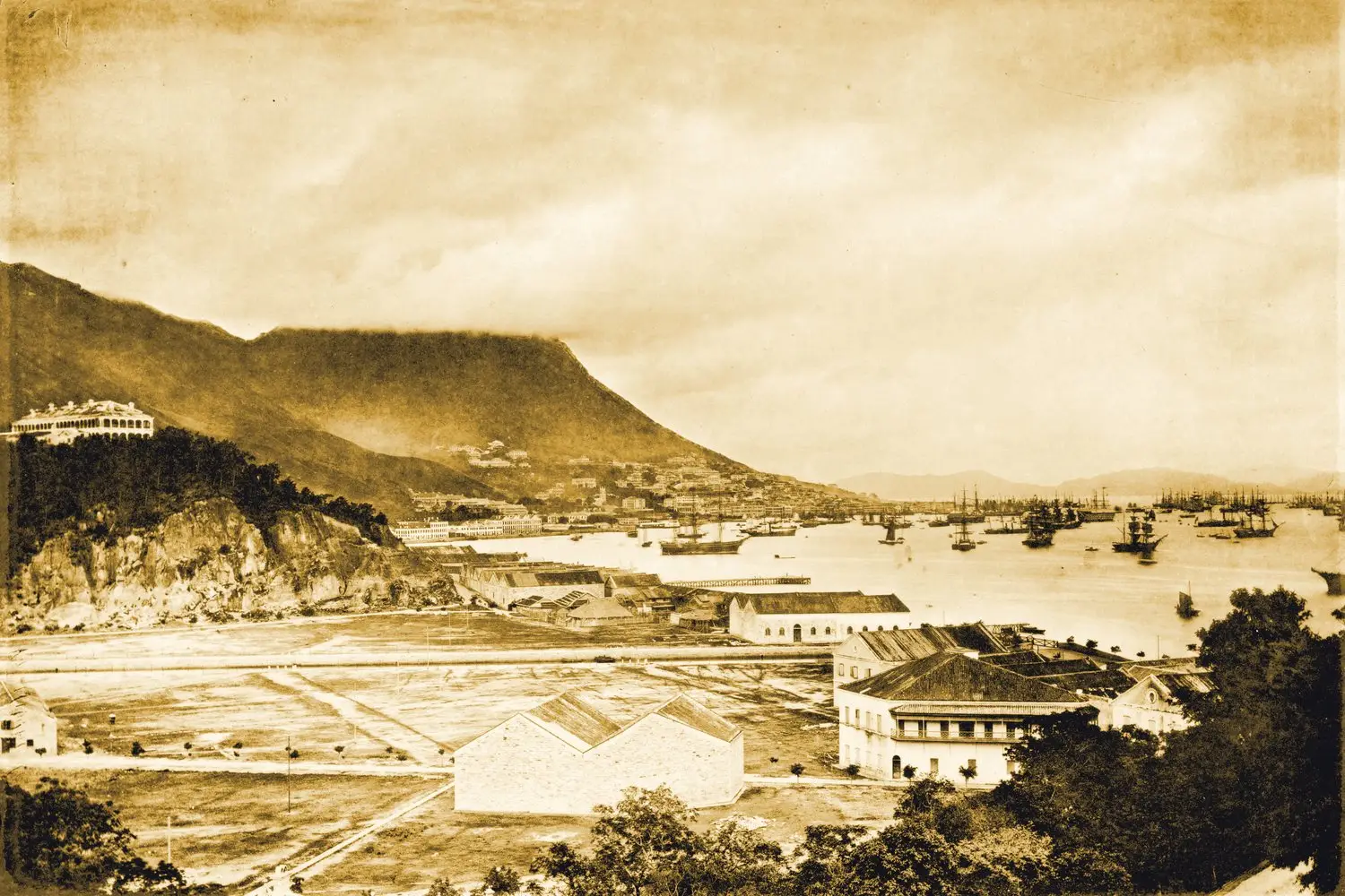 A 19th-century photograph of Hong Kong harbour, square-rigged ships at anchor below the Peak